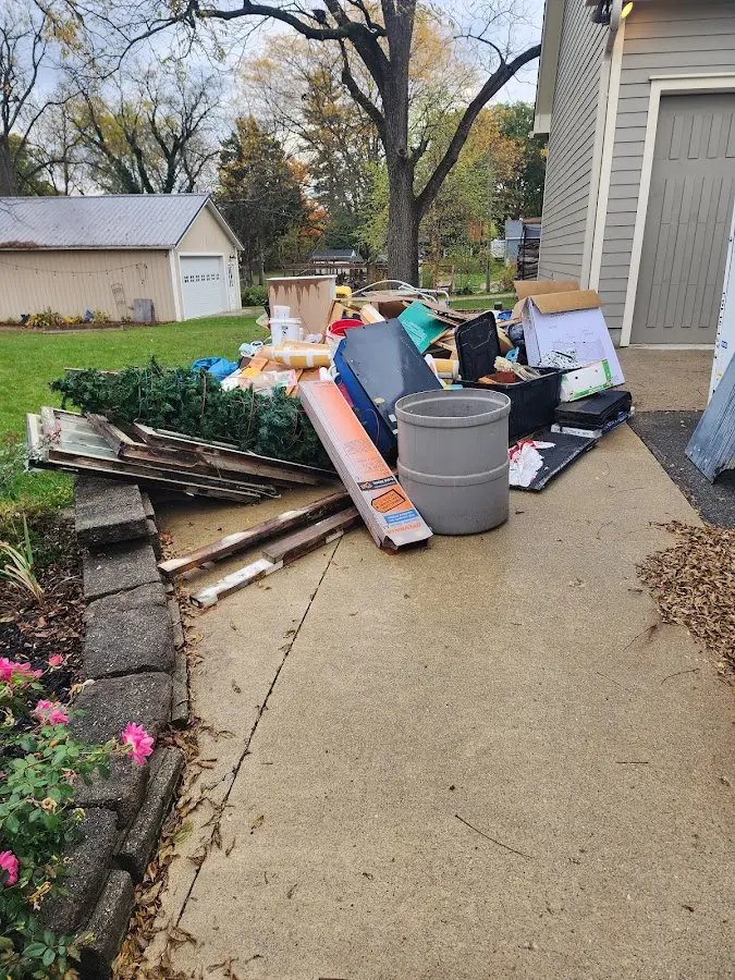 Dumpster being loaded with debris for Estate Cleanout Dumpster Rental in Pebble Creek